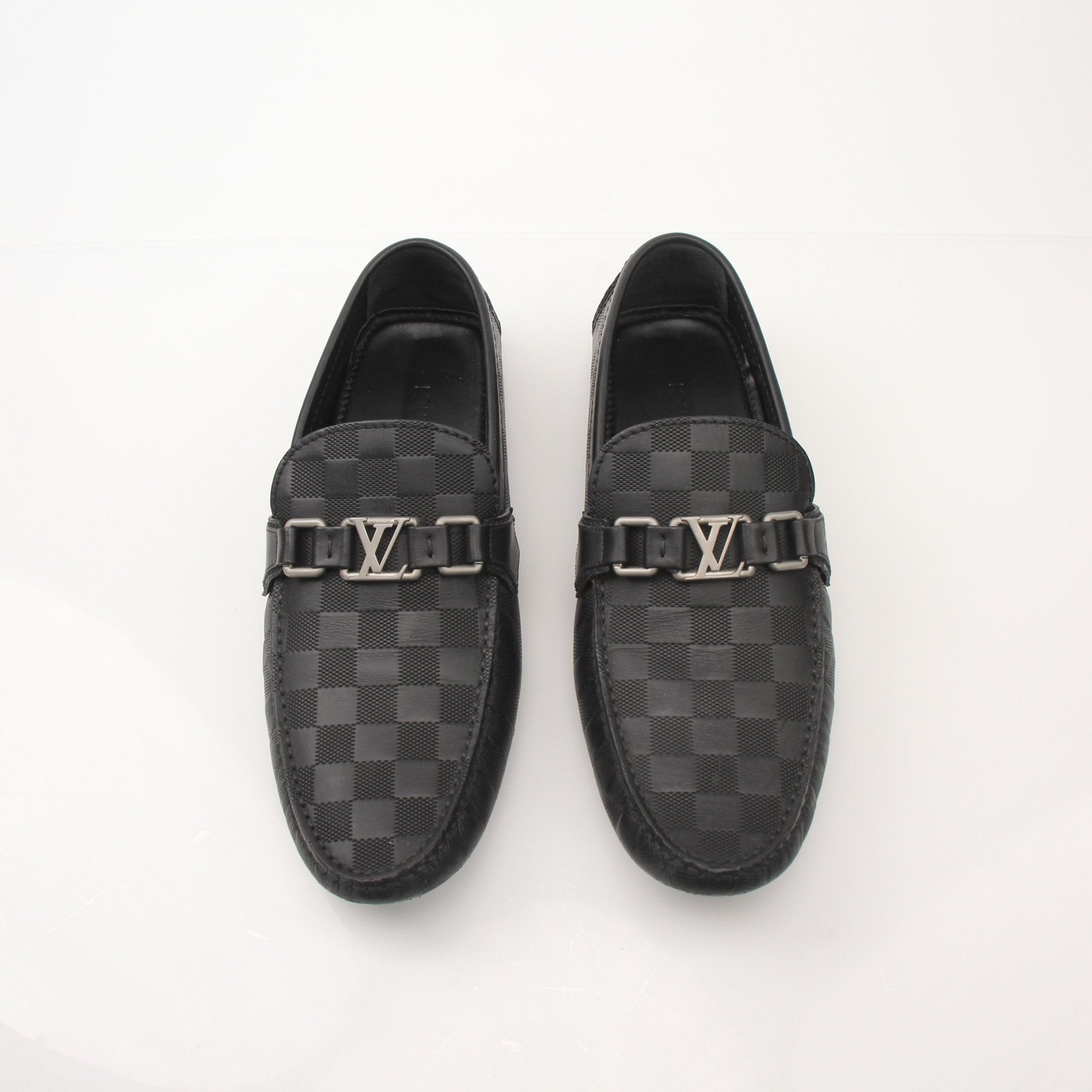 Gold & Beyond Louis Vuitton Hockenheim Moccasin shoes with leather upper and classic stitching, displayed on a neutral background.