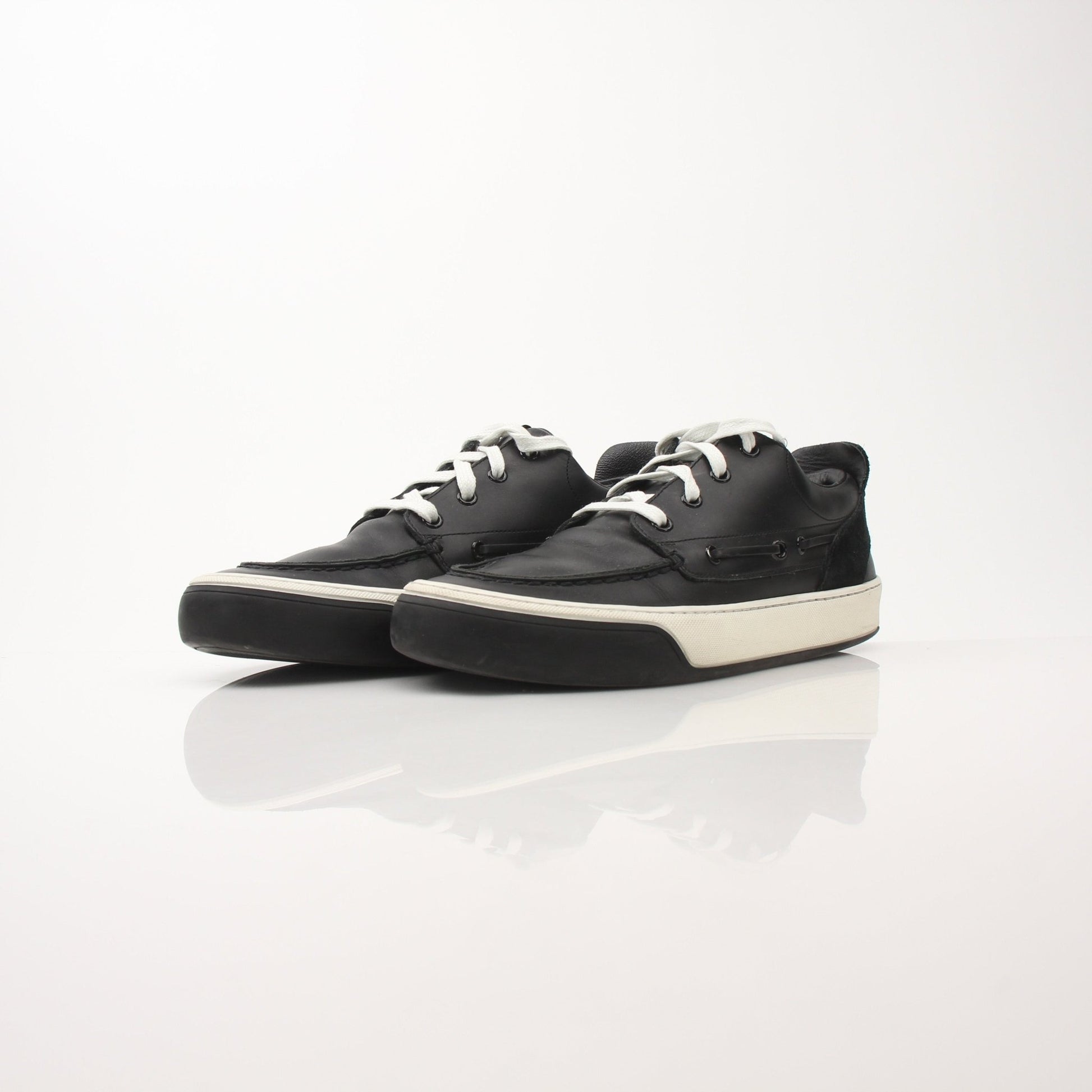 Louis Vuitton Damier low top sneakers in black and brown checkerboard pattern, displayed on a white background.