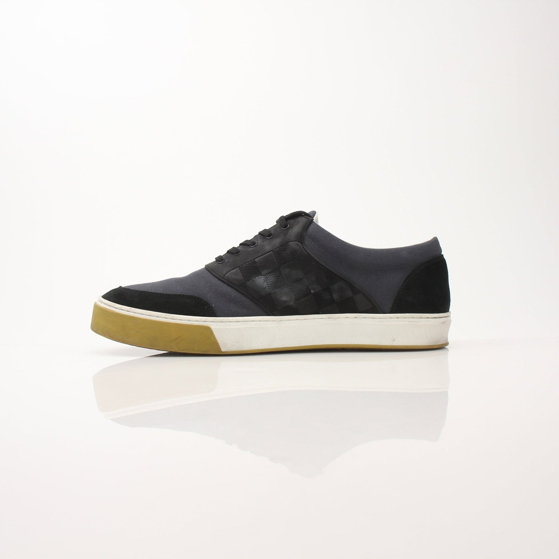 Louis Vuitton Pinball Sneakers in black and white with gold accents, featuring a stylish, modern shoe design from Gold & Beyond.