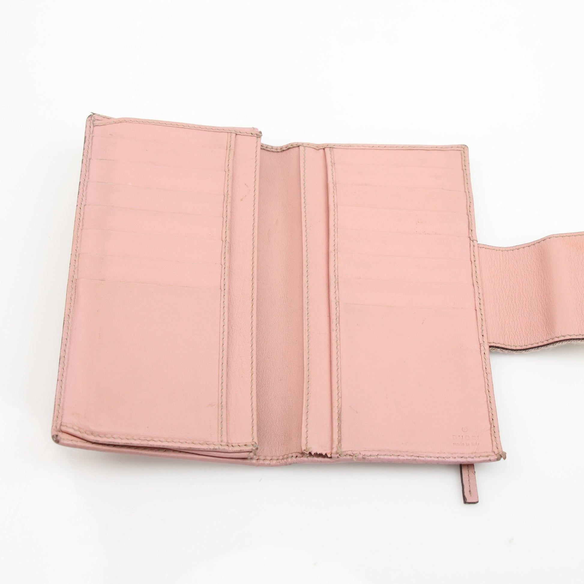 Pink Gucci GG Continental wallet with gold accents, featuring multiple card slots and a sleek design.