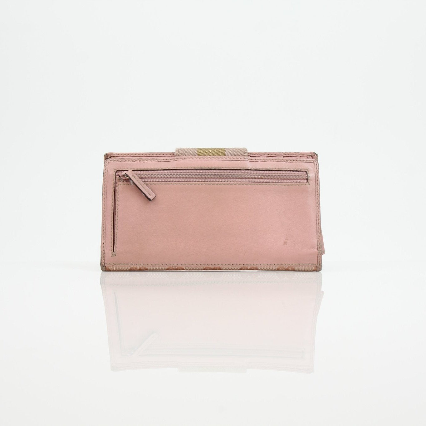 Gucci pink GG continental wallet with gold accents, showcasing the signature monogram pattern and elegant leather details.