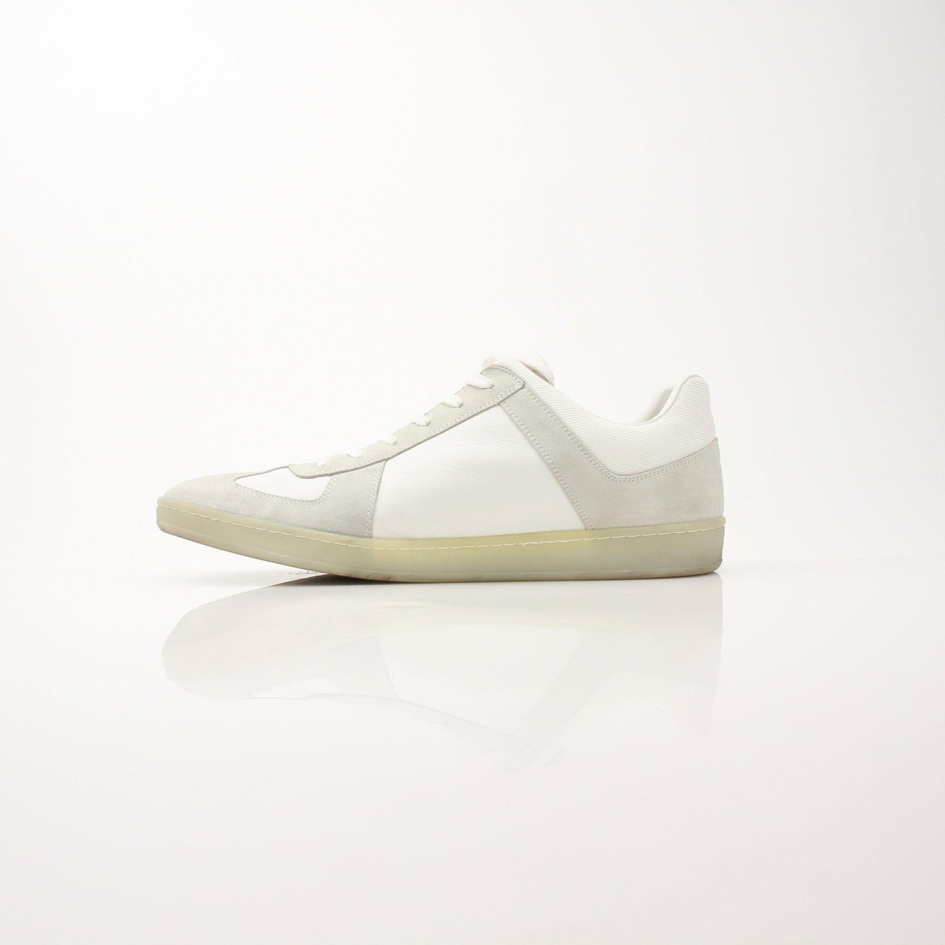 White Louis Vuitton low top sneakers by Gold & Beyond, featuring sleek design and classic branding, displayed on a plain background.