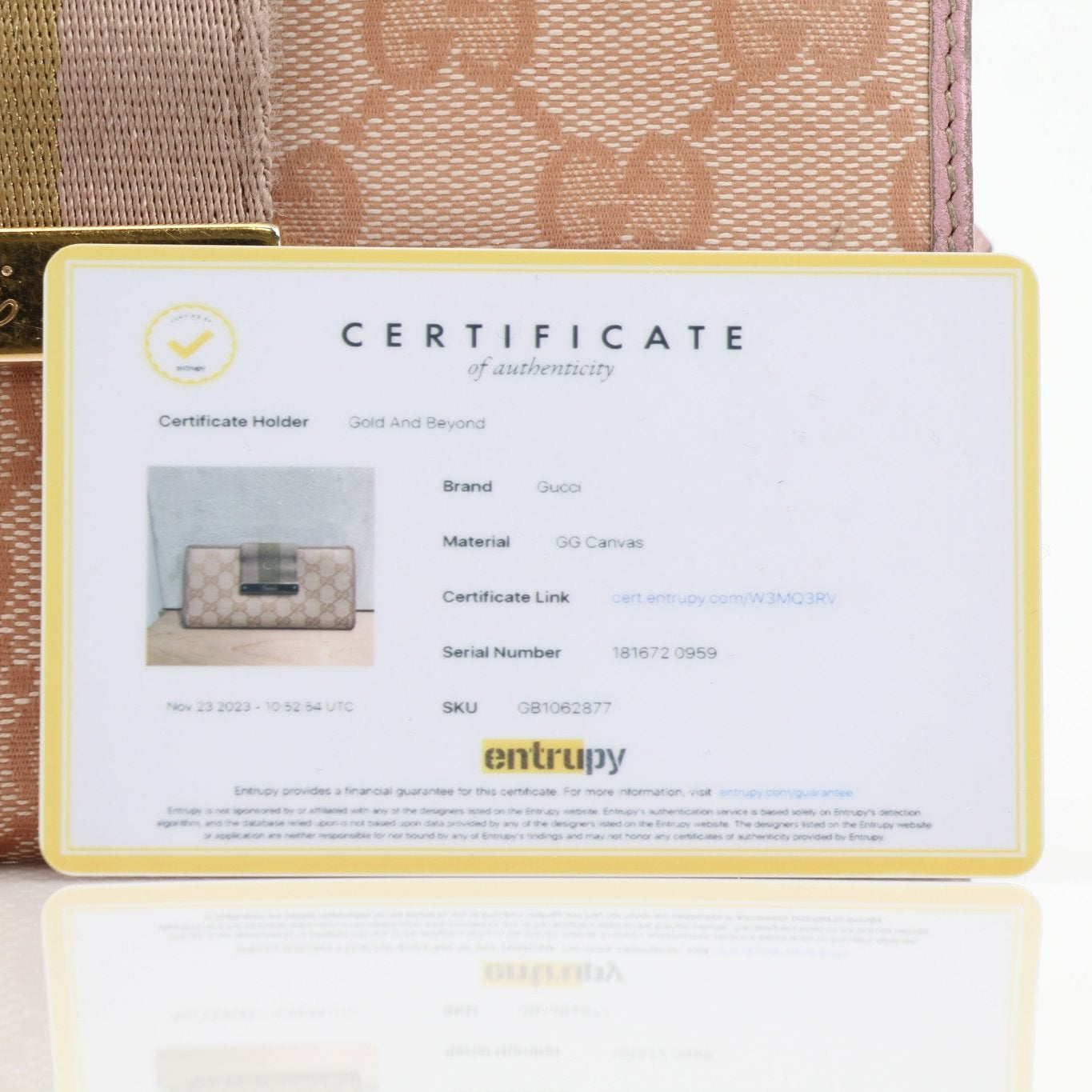 Gucci pink GG continental wallet with gold hardware, showcasing its stylish design and textured leather exterior.