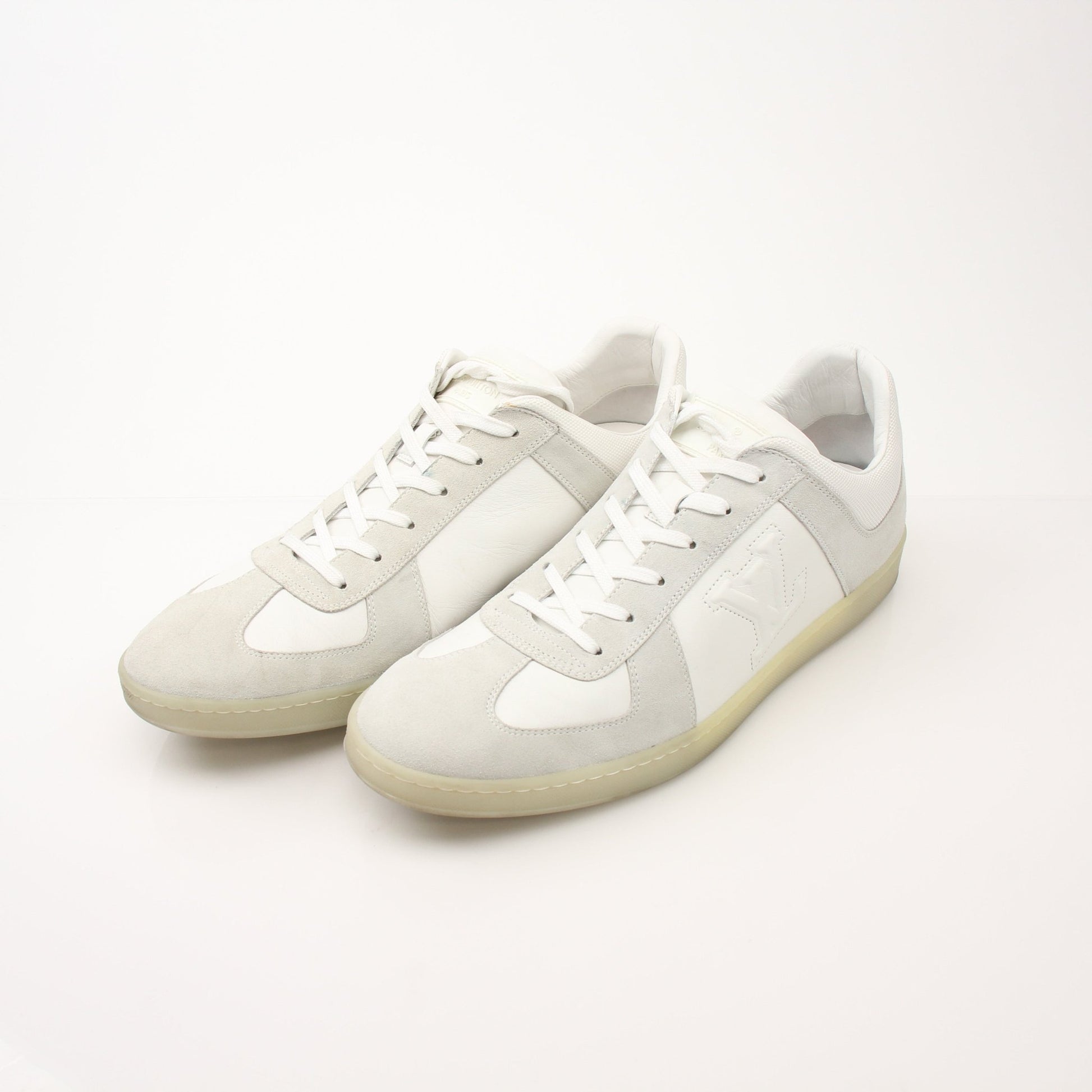White Louis Vuitton low top sneakers by Gold & Beyond, showcasing sleek design and stylish footwear for casual wear.