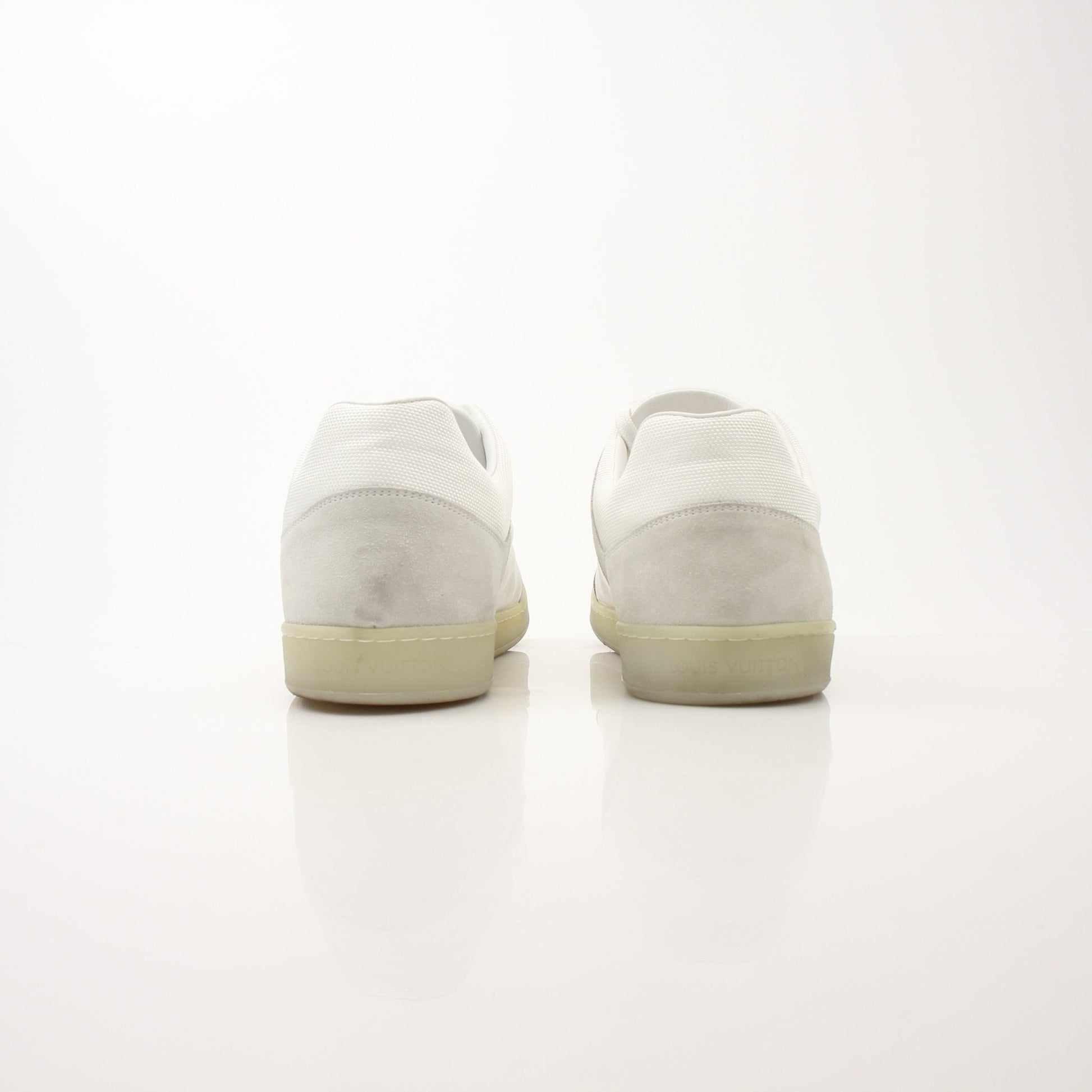 Gold & Beyond white Louis Vuitton low top sneakers with sleek leather design and subtle branding details.