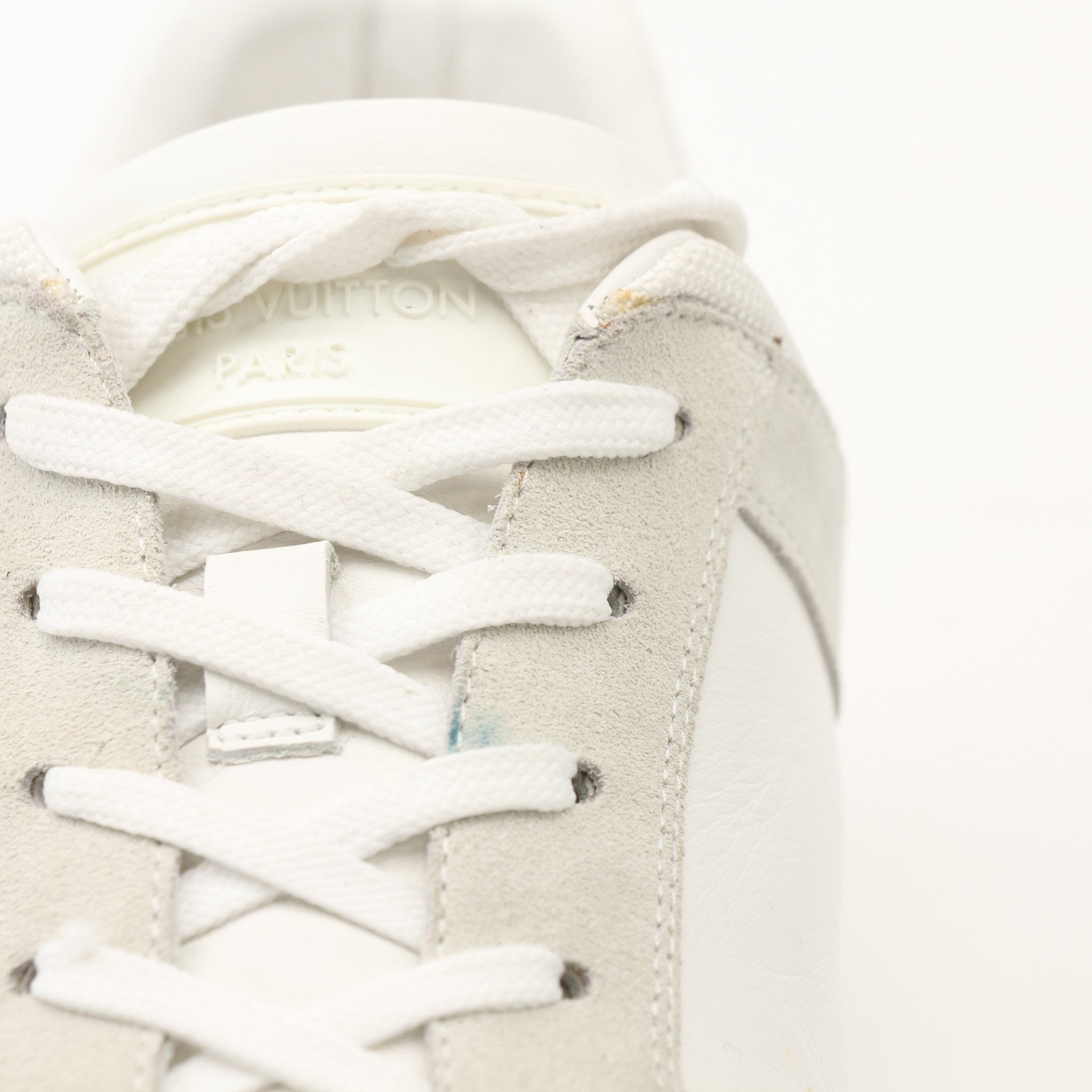 White Louis Vuitton low top sneakers for women from Gold & Beyond, featuring a sleek leather design and classic branding.