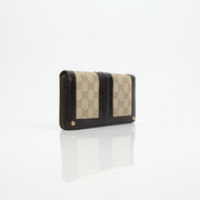 Gucci crocodile canvas wallet with gold accents, featuring multiple card slots and a sleek design.