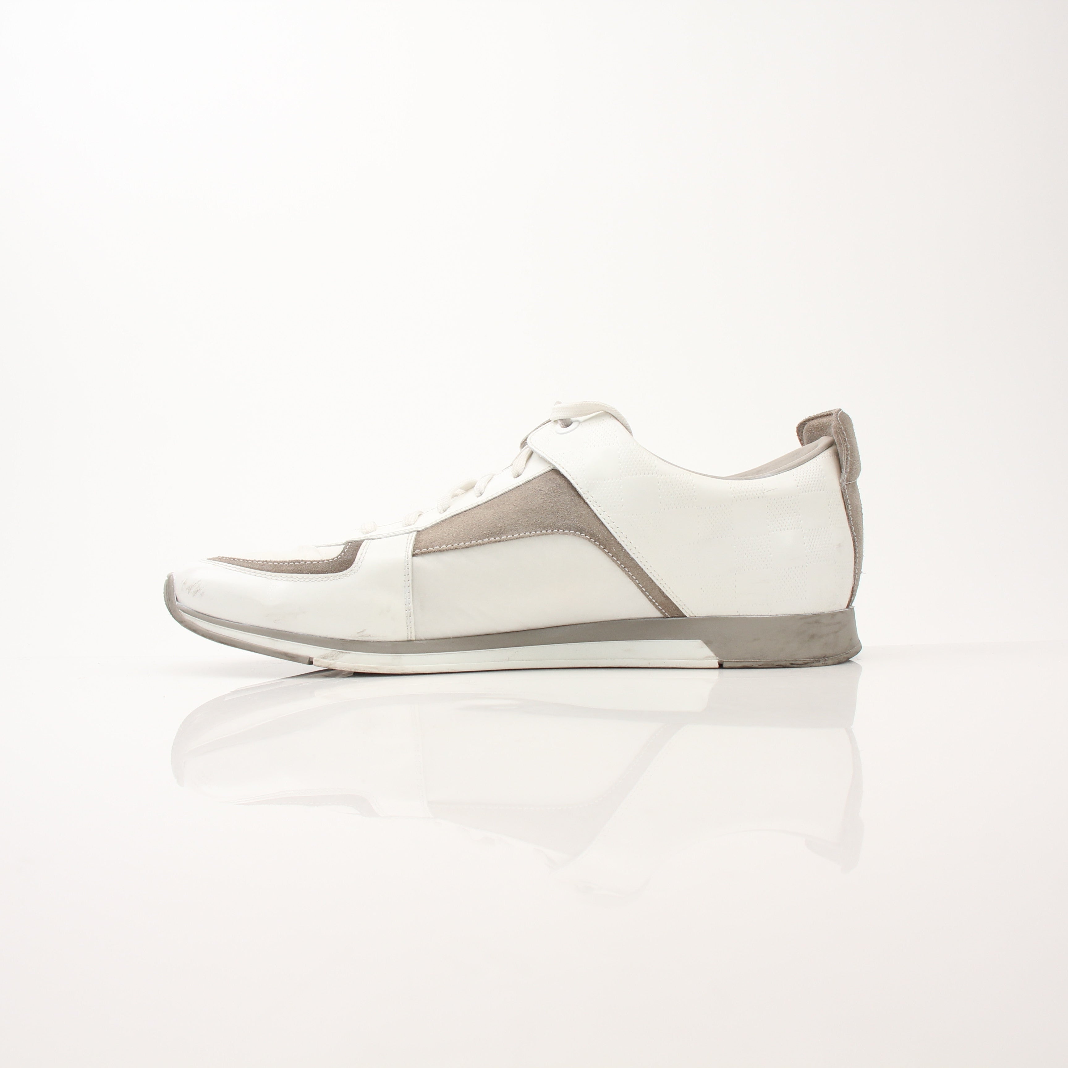Louis Vuitton Damier Trainers shoes with black and brown checkered pattern and white rubber soles, designed for casual wear.