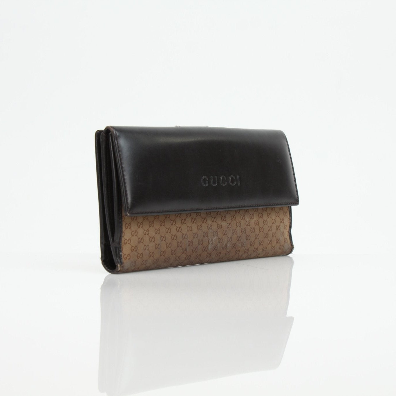 Gold & Beyond Gucci Guccissima canvas wallet showing signature monogram pattern and compact design on a neutral background.