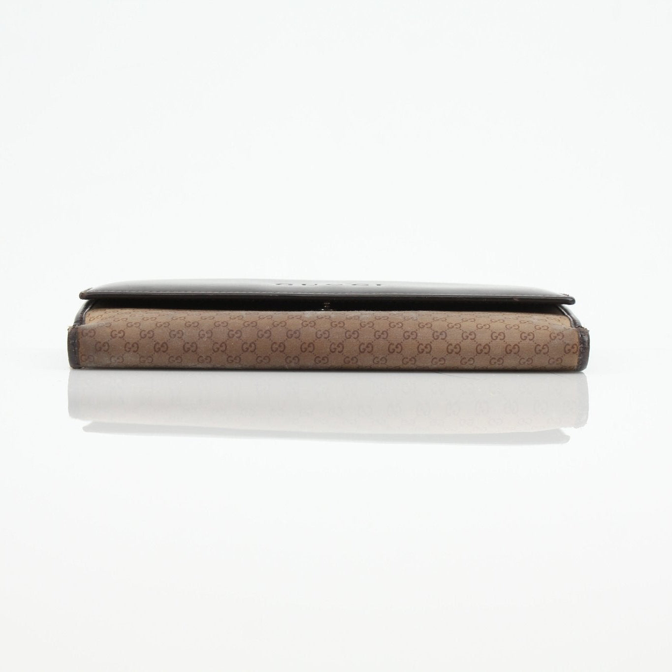 Gucci Guccissima canvas wallet with gold accents, featuring signature pattern and compact design for everyday use.