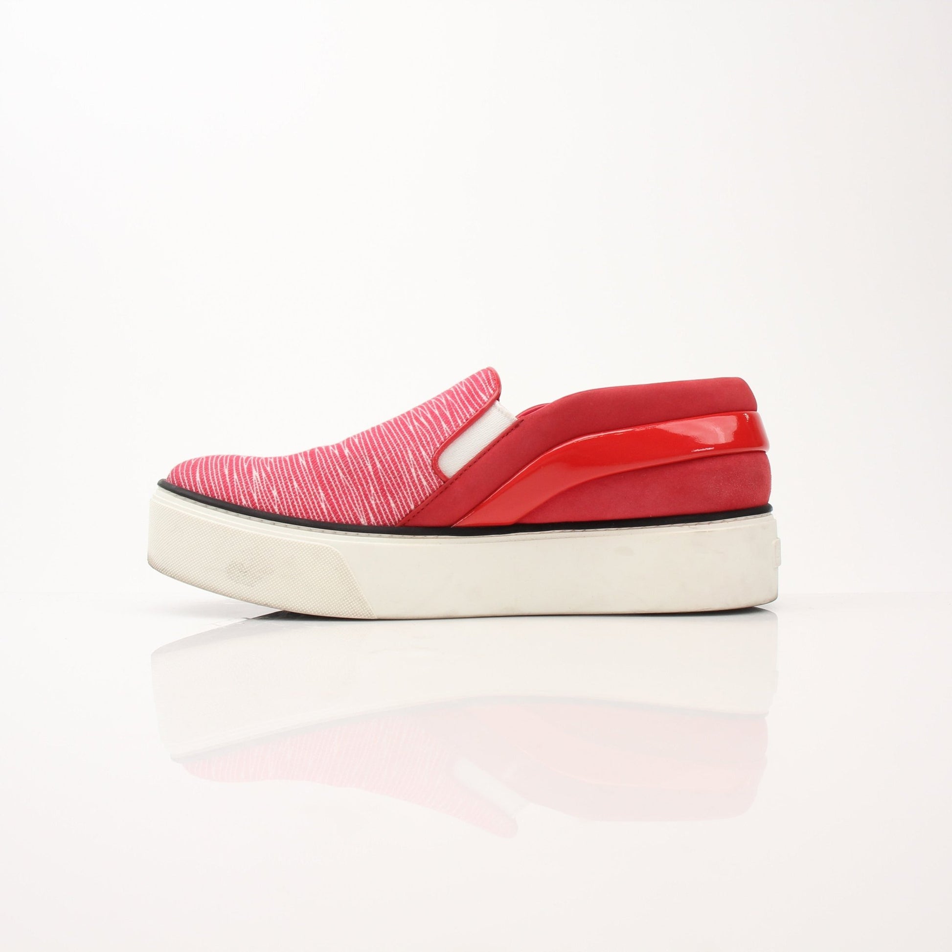 Red Louis Vuitton slip-on sneakers with white soles and gold accents, designed by Gold & Beyond.