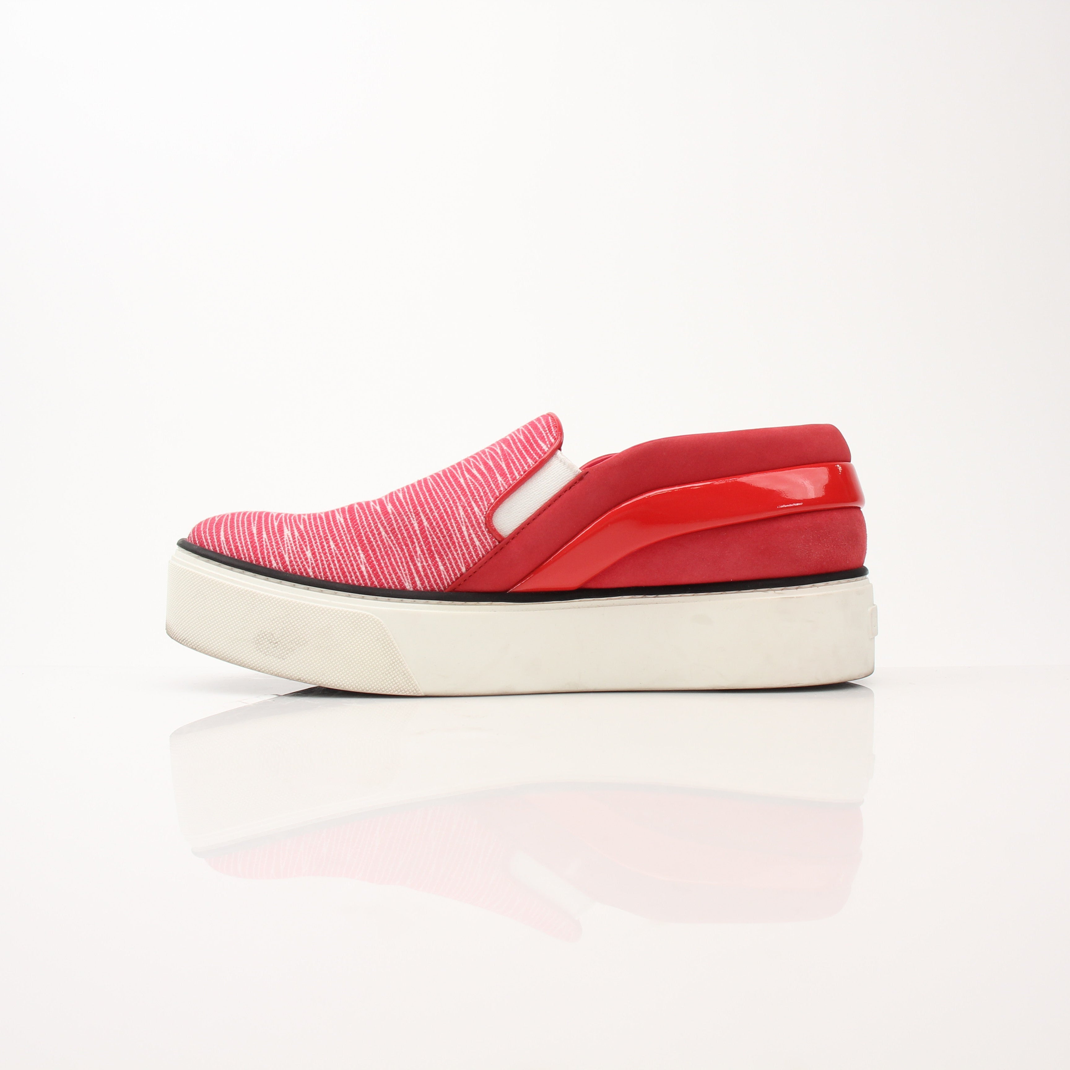 Red Louis Vuitton slip-on sneakers with white soles and gold accents, designed by Gold & Beyond.