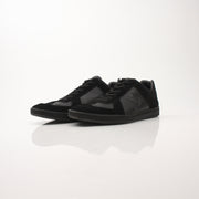 Black Louis Vuitton low top sneakers by Gold & Beyond, showcasing sleek leather uppers and stylish design details.