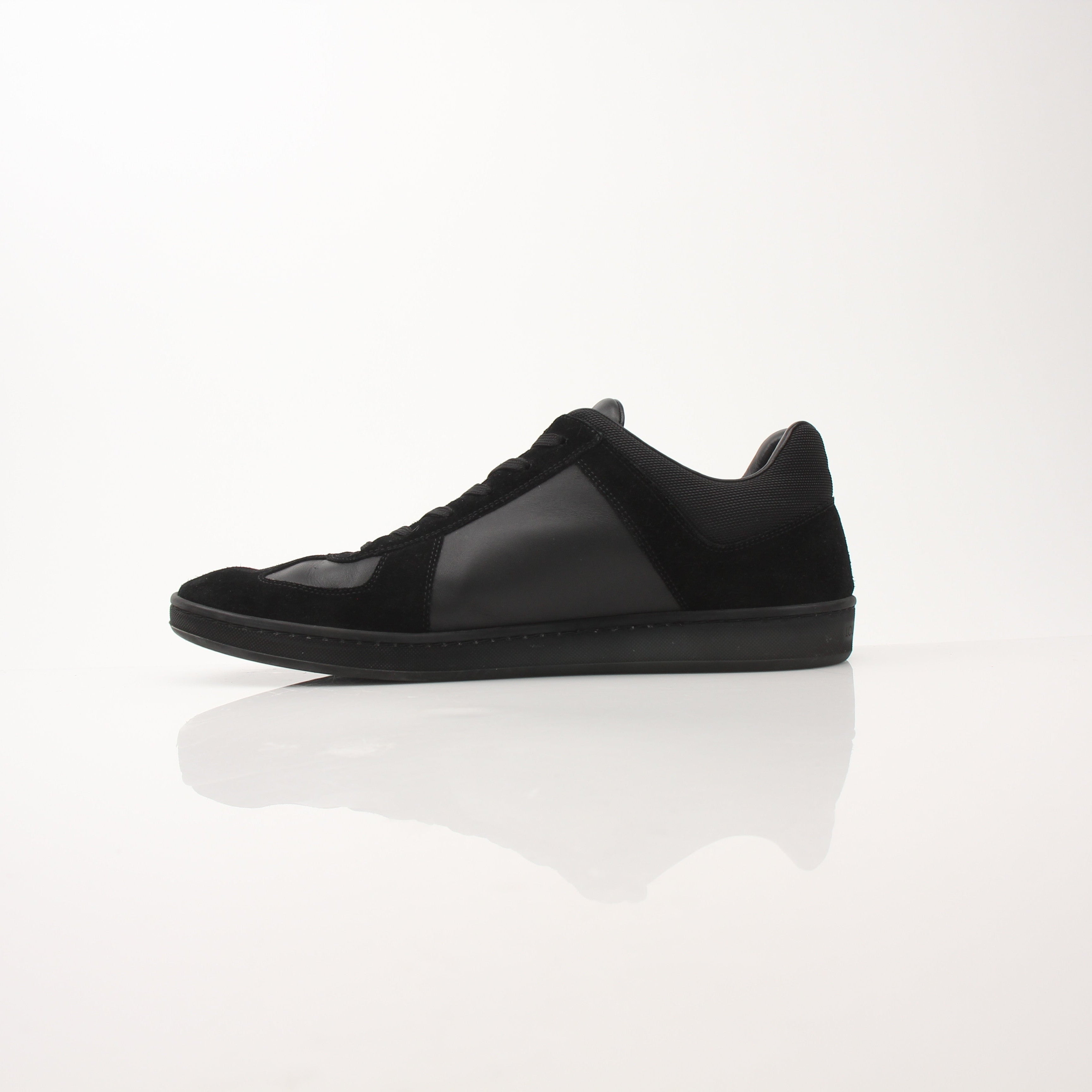 Louis Vuitton black low top sneakers by Gold & Beyond, featuring sleek design, white soles, and classic branding details.