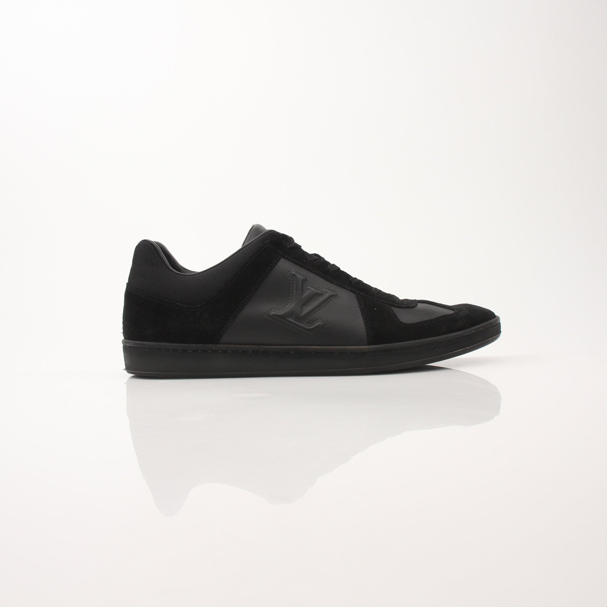 Black Louis Vuitton low top sneakers by Gold & Beyond, featuring sleek design and white rubber soles.