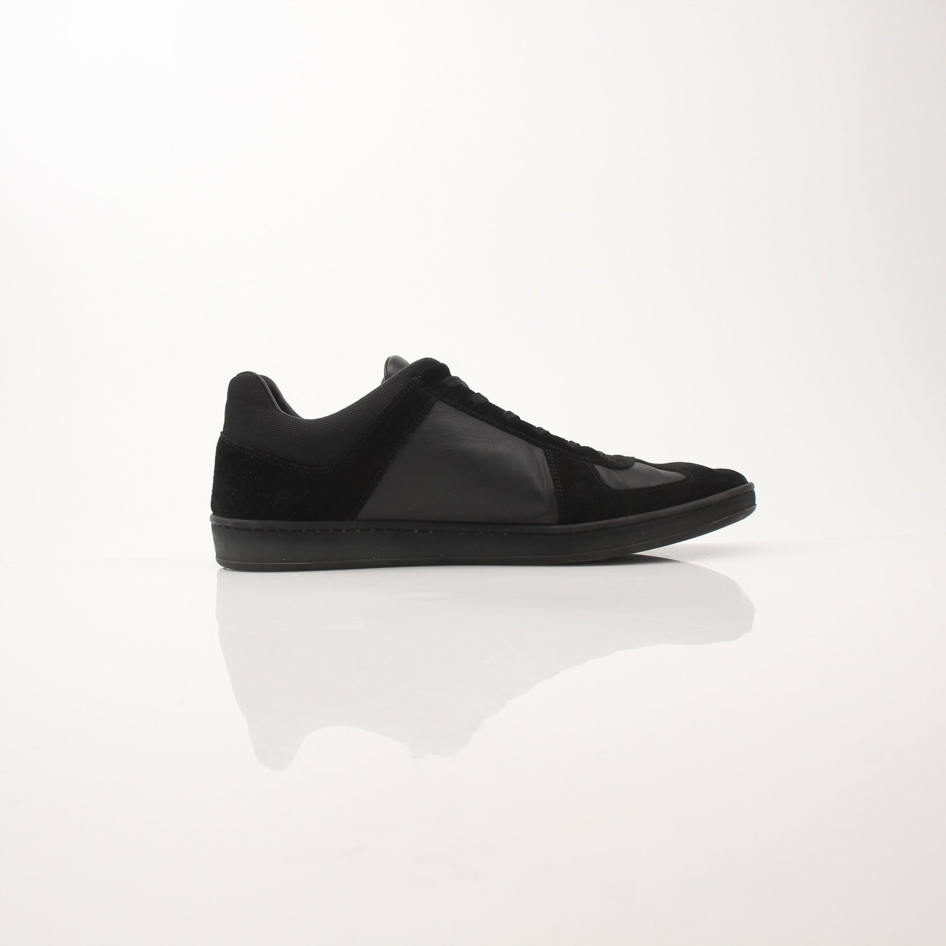 Black Louis Vuitton low top sneakers by Gold & Beyond, featuring sleek design and white rubber soles.
