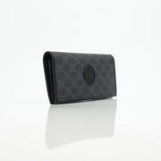 Gucci GG Supreme black wallet with gold accents, featuring a sleek design and multiple card slots, by Gold & Beyond.