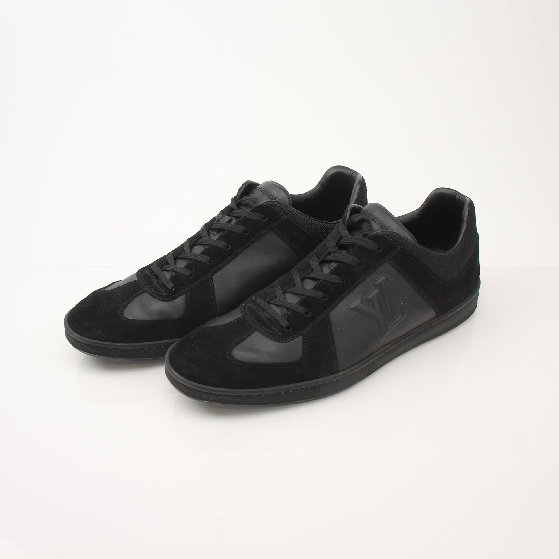 Gold & Beyond black Louis Vuitton low top sneakers with sleek design and white rubber soles, casual shoes for men.