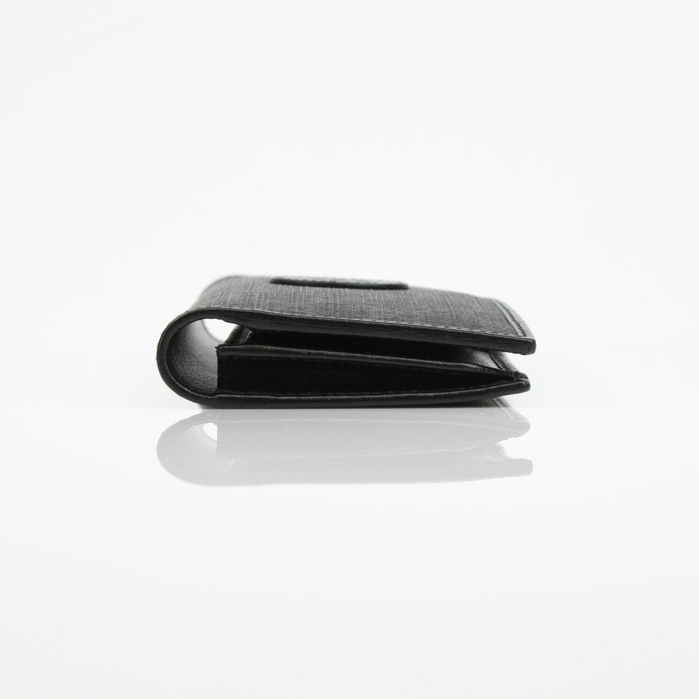 Gucci GG Supreme black wallet with gold accents, featuring a sleek design and multiple card slots.