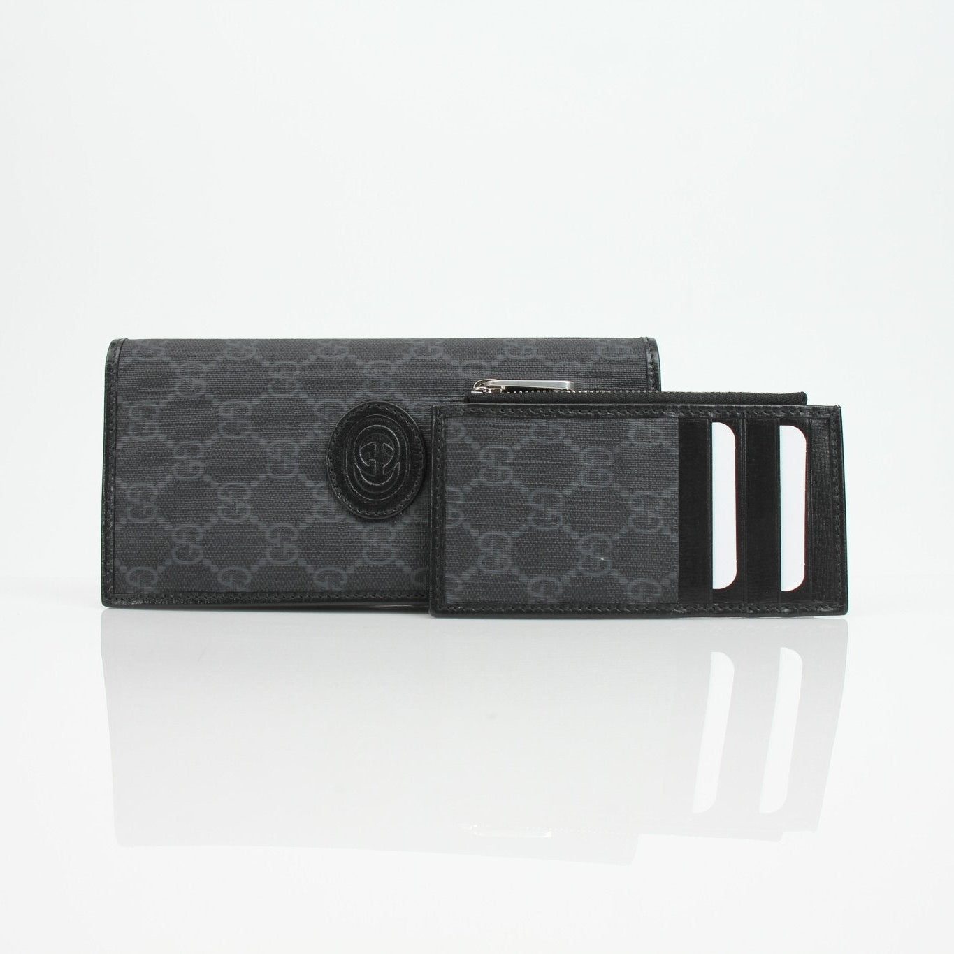 Gucci GG Supreme black wallet with gold accents, showcasing its sleek design and premium leather details.