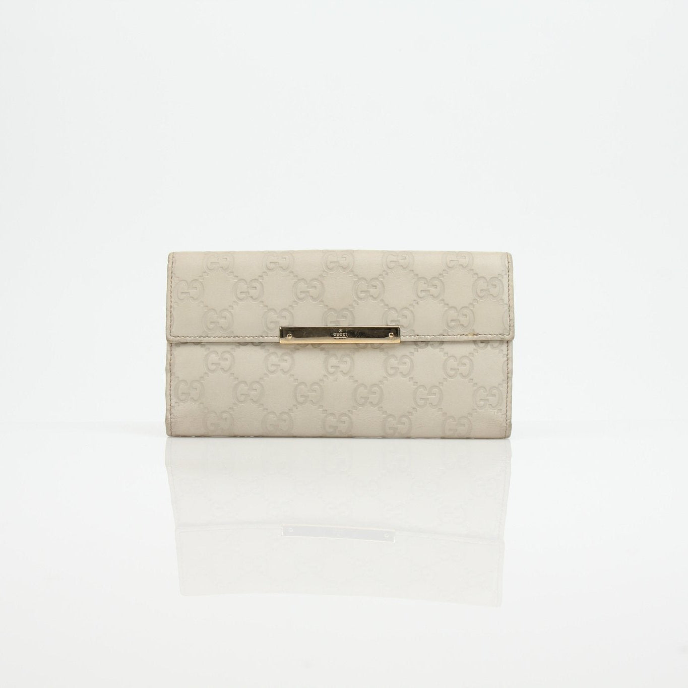 Gucci beige Guccissima wallet with gold accents, featuring signature monogram pattern and leather interior.
