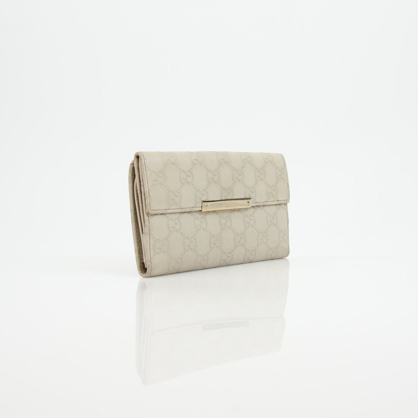 Gucci beige Guccissima wallet with gold accents, featuring signature monogram pattern and leather interior.