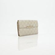 Gucci beige Guccissima wallet with gold accents, featuring signature monogram pattern and leather interior.