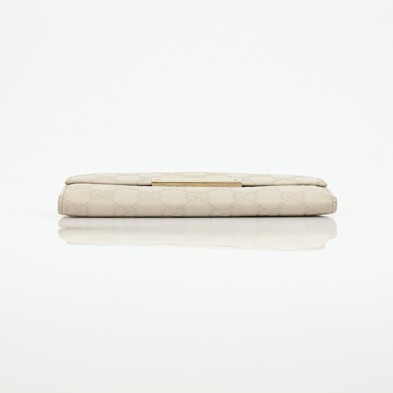 Gucci beige Guccissima wallet with gold accents, featuring signature monogram pattern and leather interior.