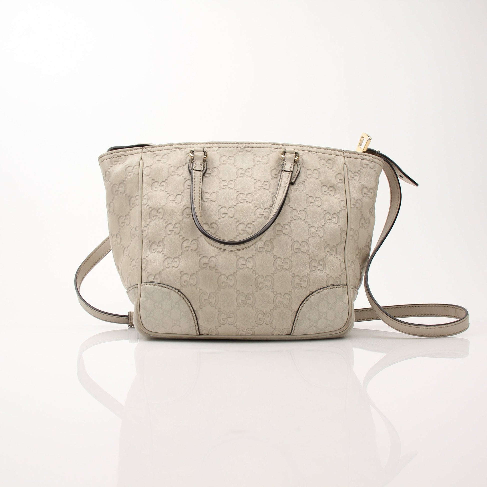 Gucci beige Bree tote handbag with gold accents, featuring woven textured design and sturdy leather handles.