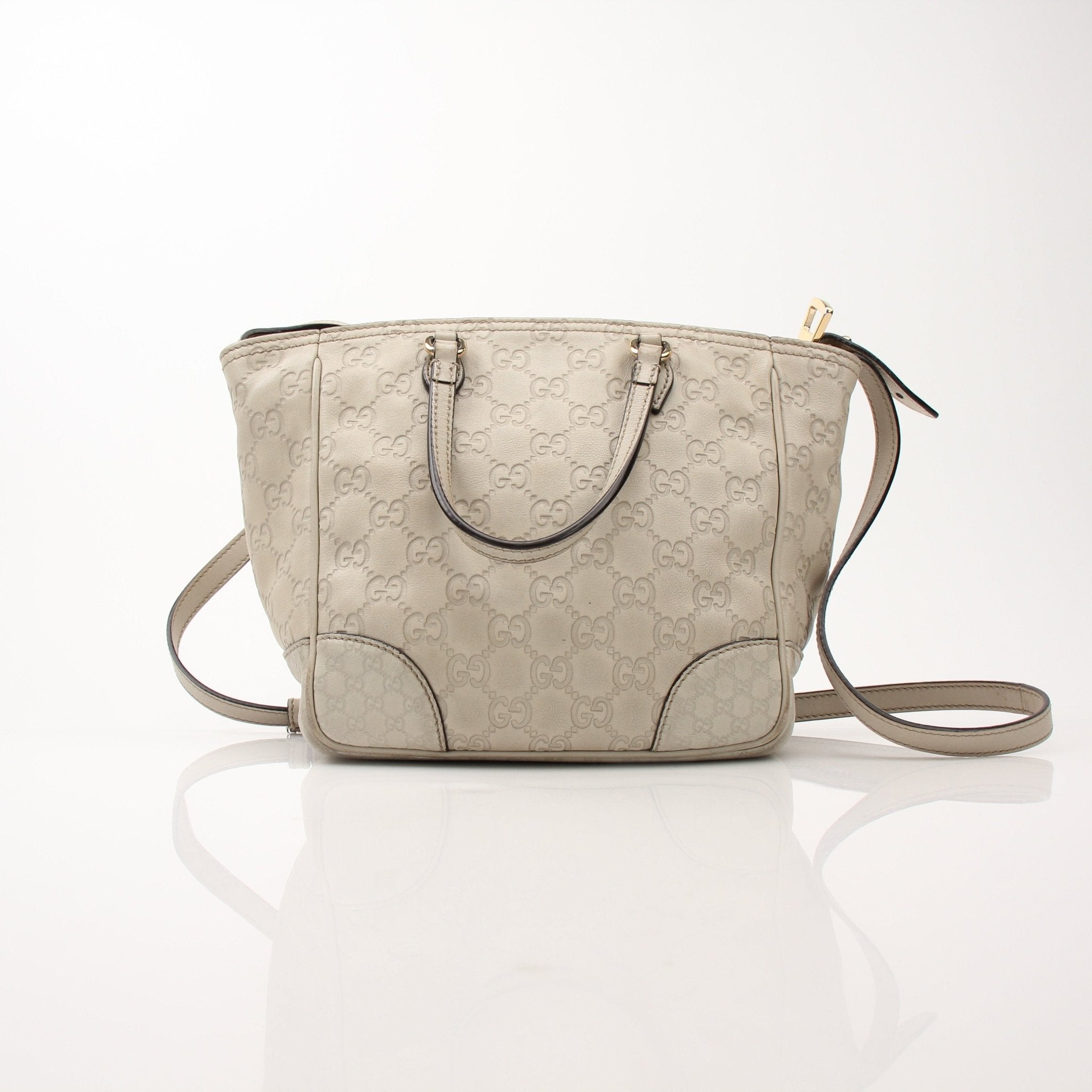 Gucci beige Bree tote handbag with gold accents, featuring woven textured design and sturdy leather handles.