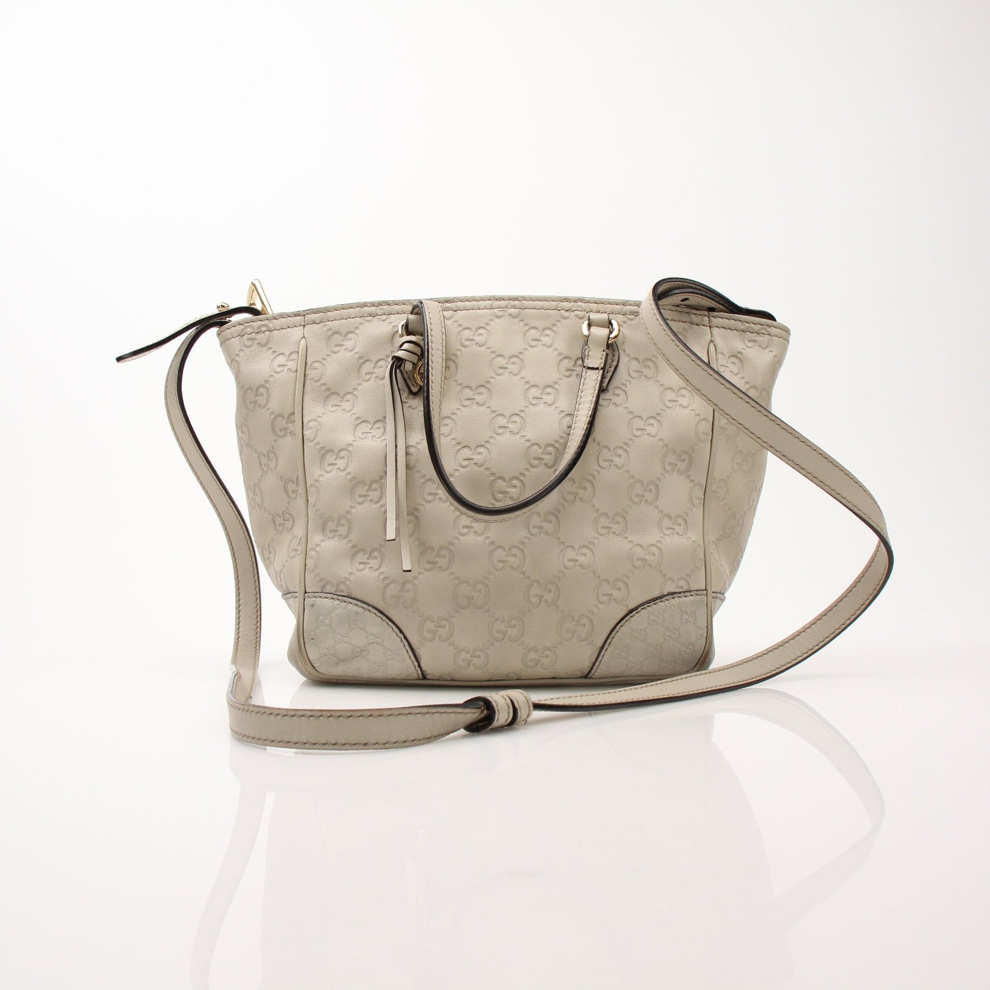 Gucci beige Bree tote handbag with gold accents, featuring stylish handles and spacious interior for everyday use.
