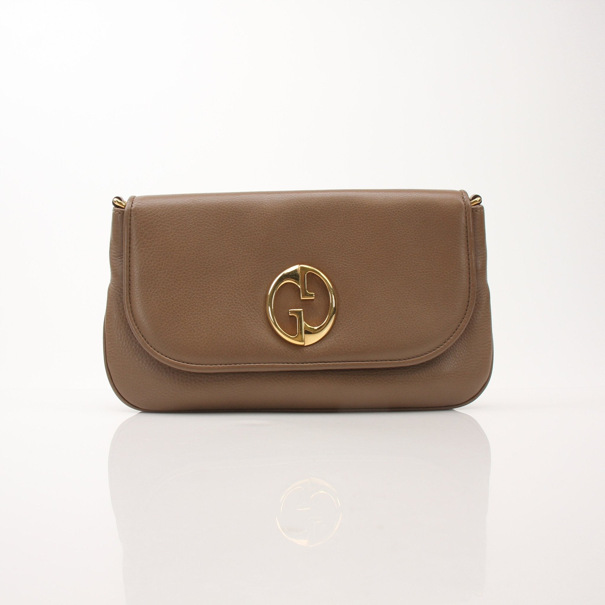 Gucci brown pebbled leather '1973' shoulder handbag with gold accents, featuring a structured design and adjustable strap.