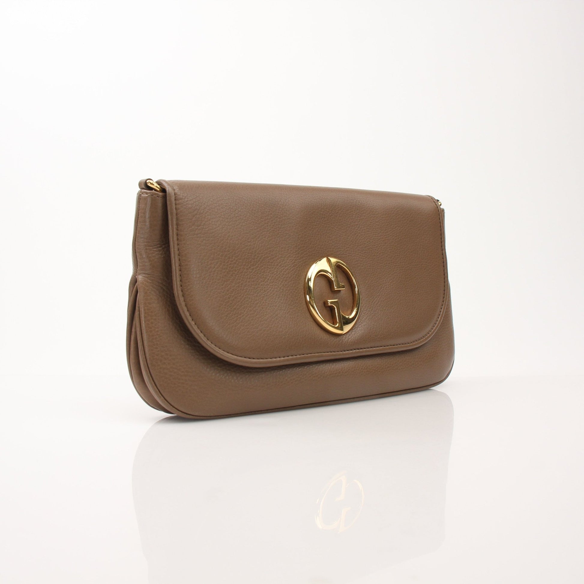 Gucci brown pebbled leather '1973' shoulder handbag with gold accents and a structured design, displayed on a plain background.