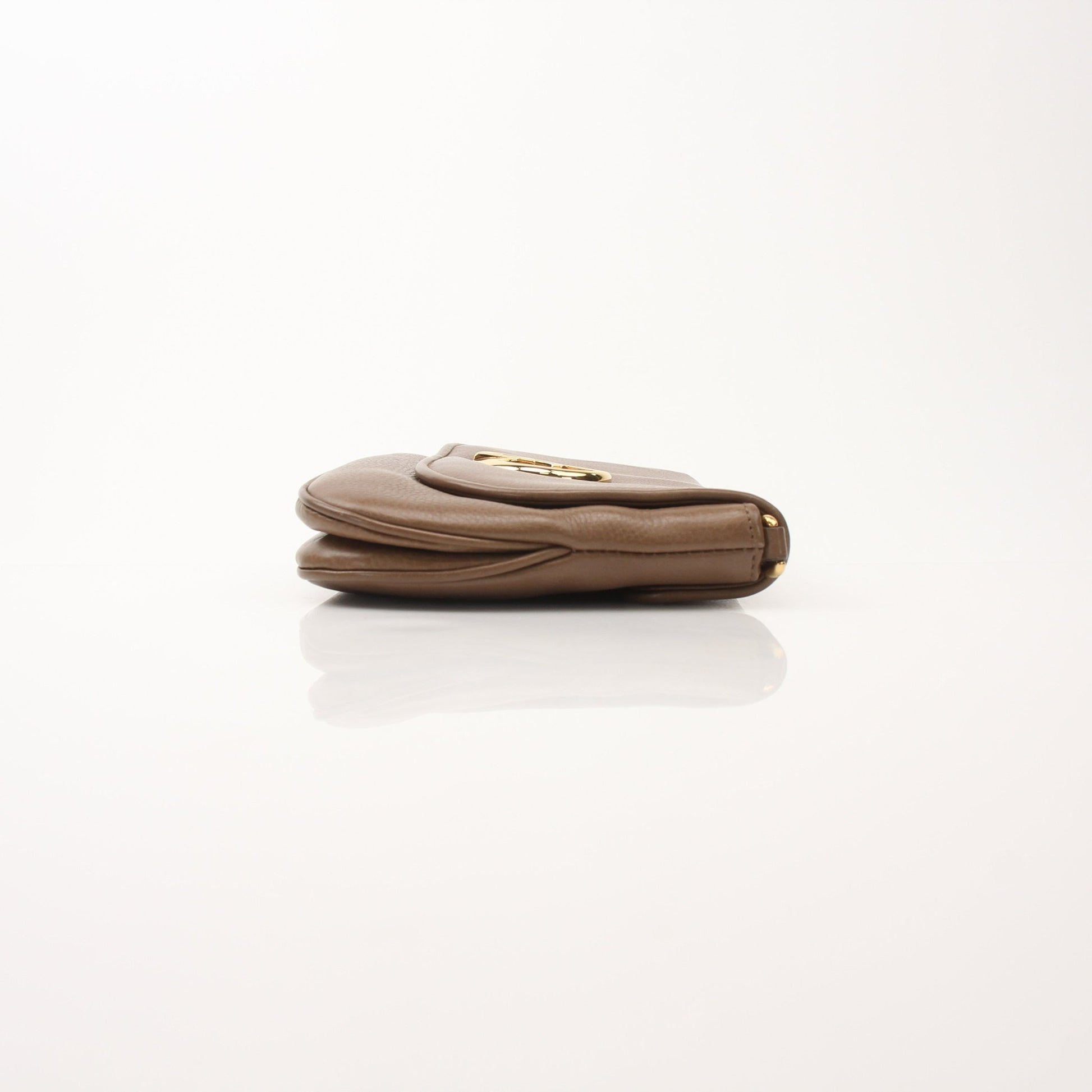 Gucci brown pebbled leather shoulder bag with '1973' detailing, stylish handbag by Gold & Beyond displayed on a neutral background.