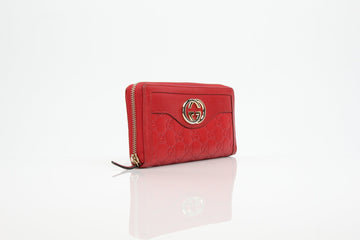 Gucci red GG Marmont zip-around wallet featuring signature logo and textured leather design.