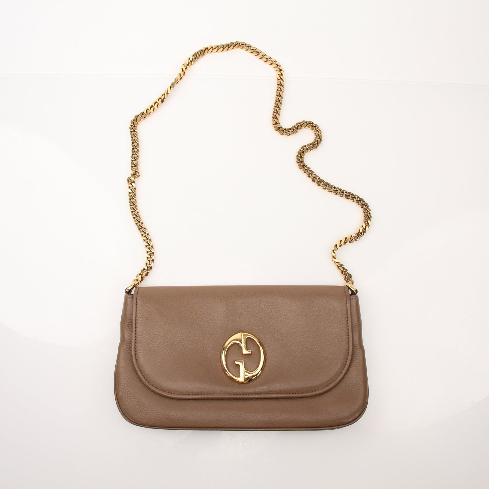 Gucci brown pebbled leather 1973 shoulder handbag with gold hardware and adjustable strap.