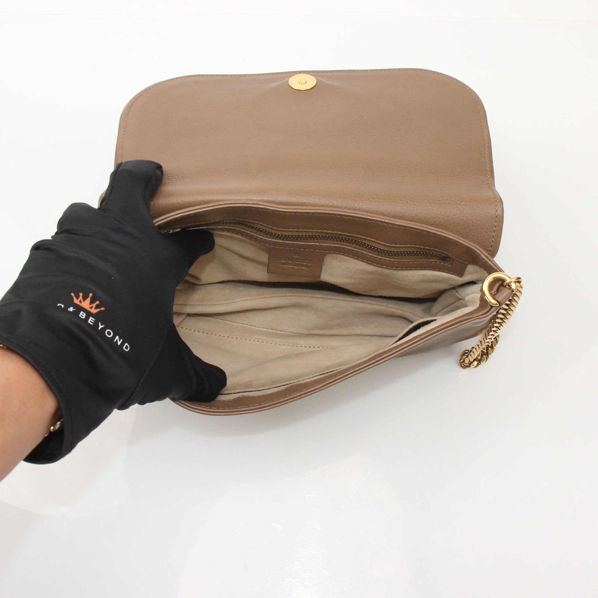 Gucci brown pebbled leather 1973 shoulder handbag with gold hardware and adjustable strap, stylish and spacious.