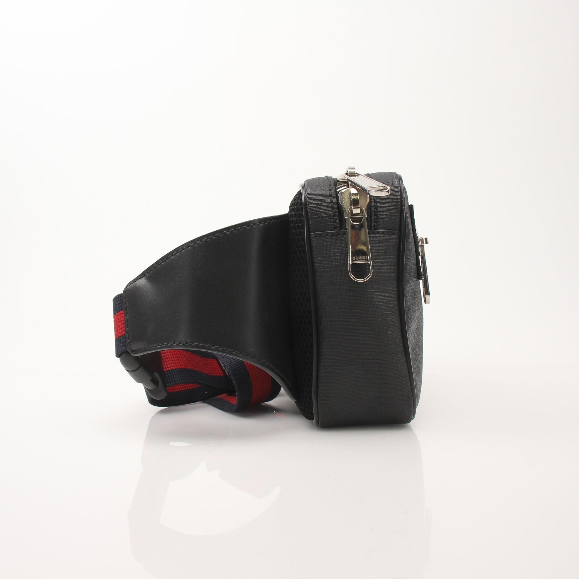 Gucci GG Supreme monogram web belt bag with leather accents, compact handbag featuring adjustable strap and signature design.