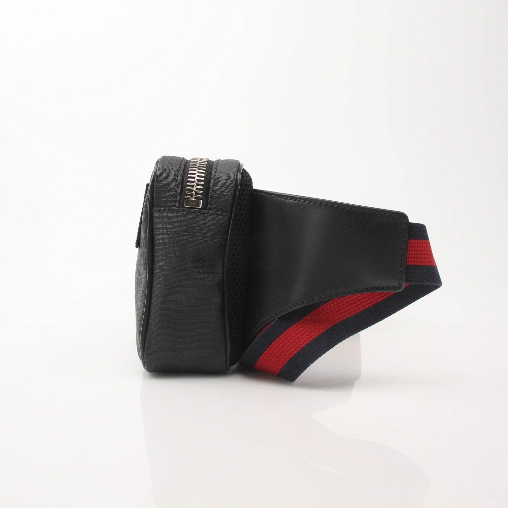 Gucci GG Supreme monogram web belt bag with adjustable strap and gold-tone hardware, featuring signature monogram pattern.