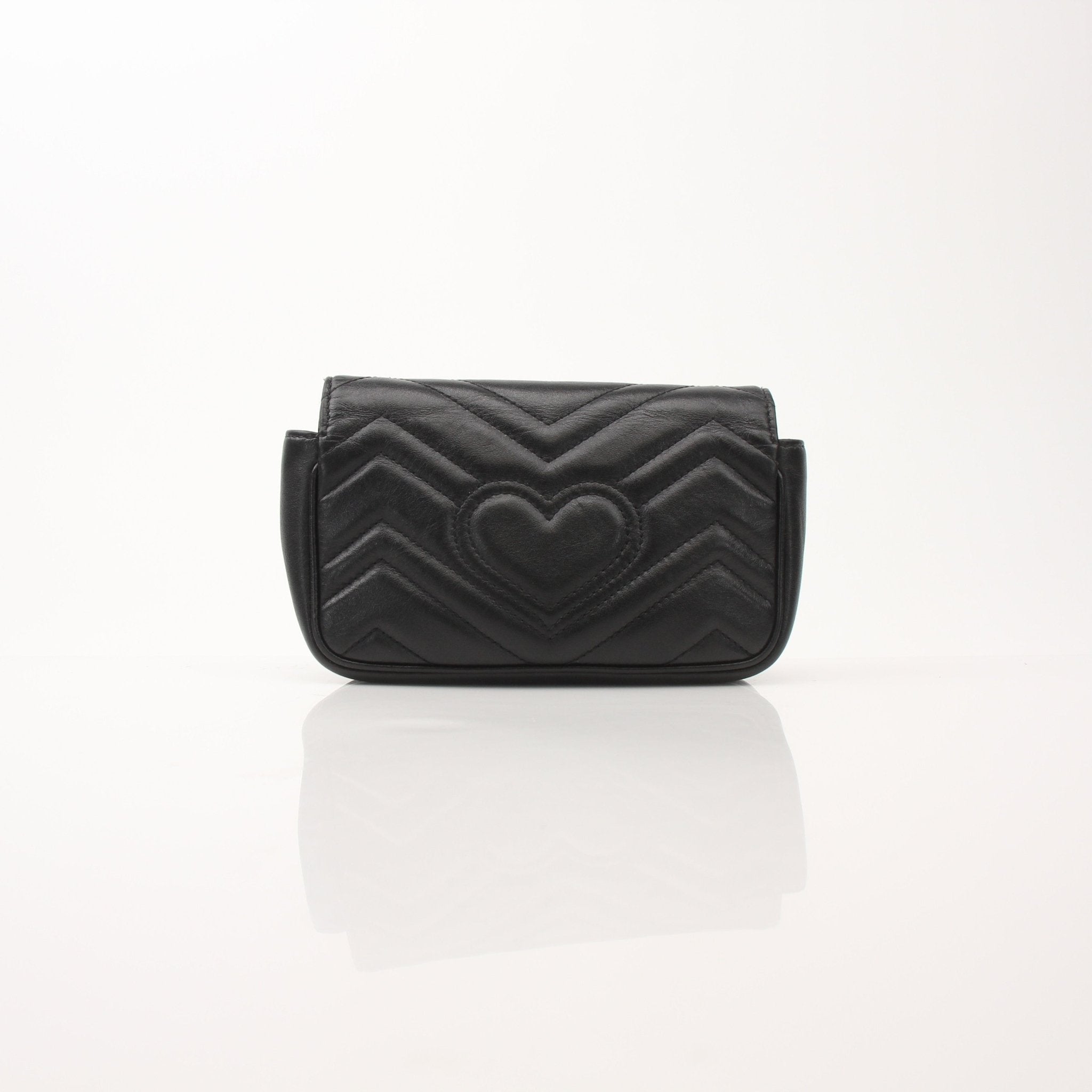 Gucci Calfskin Matelassé Super Mini GG Marmont shoulder handbag with gold hardware and quilted design.