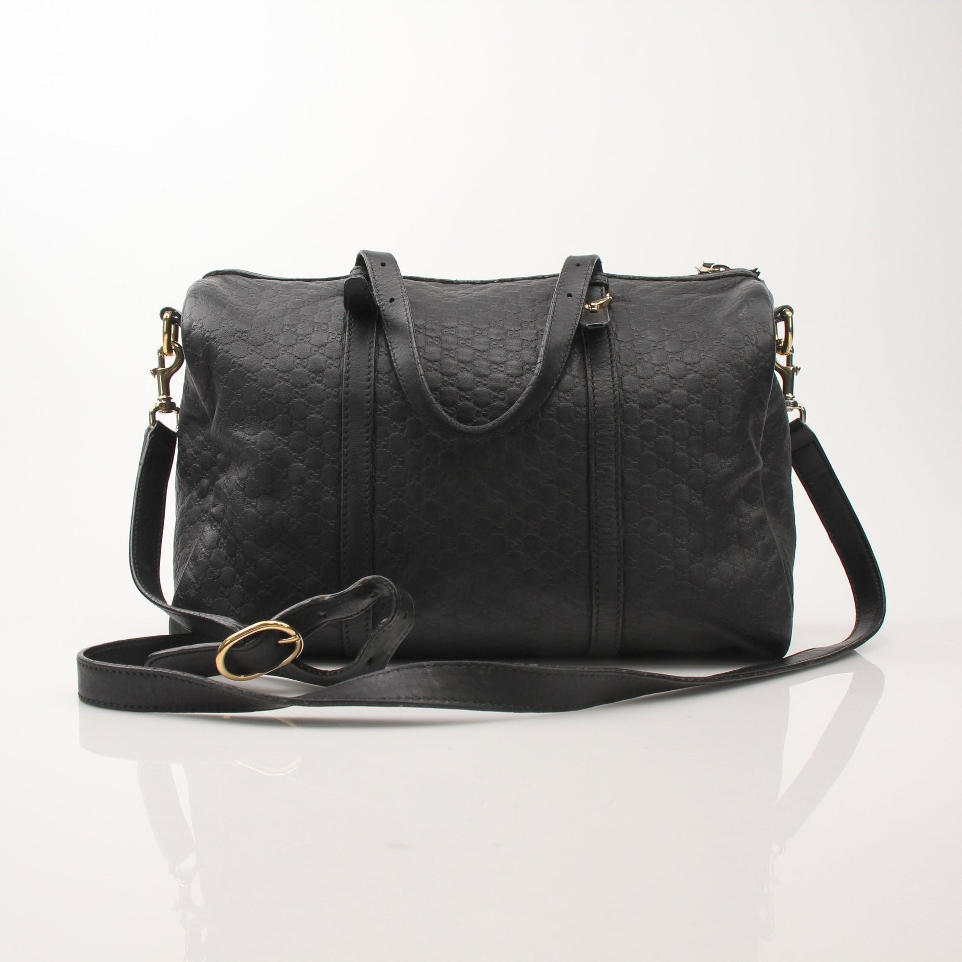 Black Gucci Joy Boston Handbag by Gold & Beyond, featuring sleek design and sturdy handles on a neutral background.