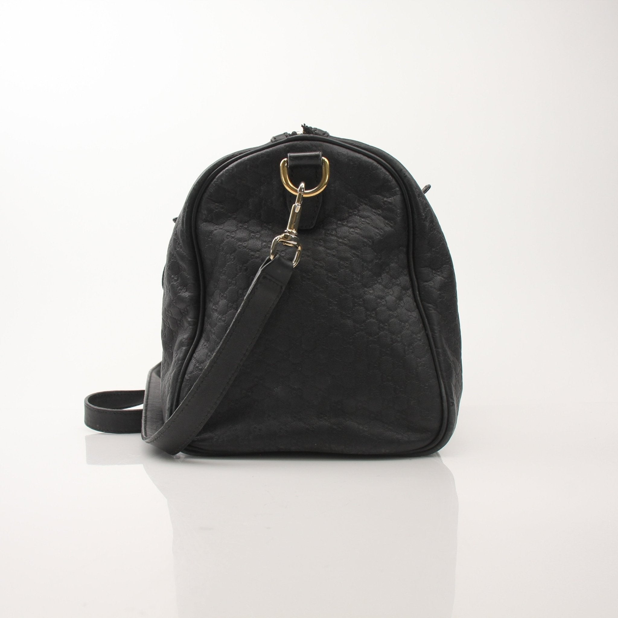 Black Gucci Joy Boston Handbag with gold hardware, featuring a structured design and top handles, by Gold & Beyond.