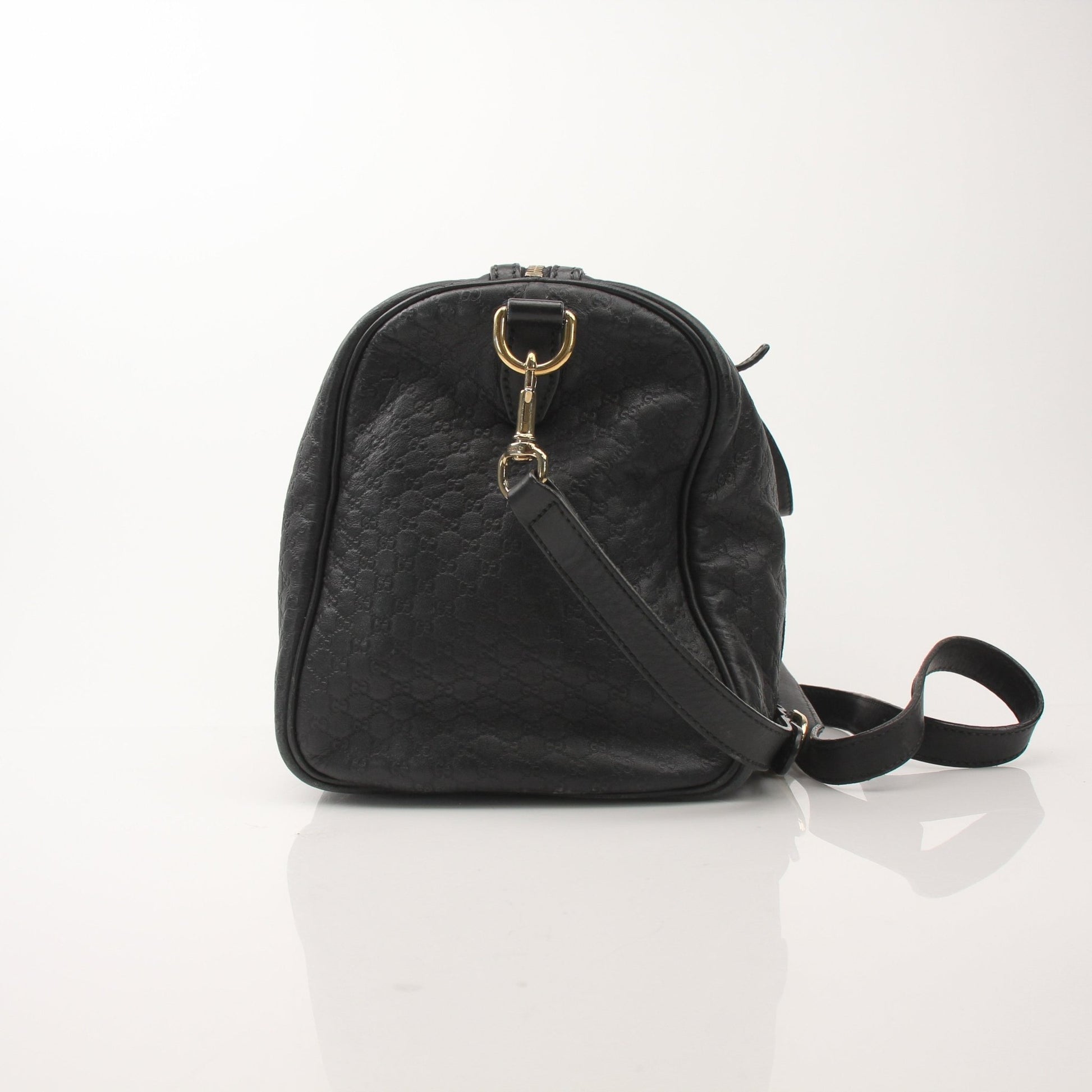 Black Gucci Joy Boston handbag by Gold & Beyond, featuring structured design and gold-tone accents, displayed on a neutral background.