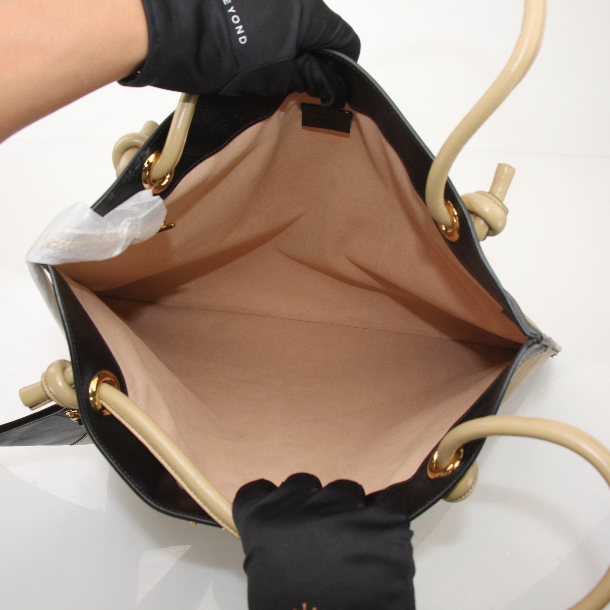 Gold & Beyond Gucci Zumi Tote Bag, a stylish handbag with structured design and gold accents, displayed against a neutral background.