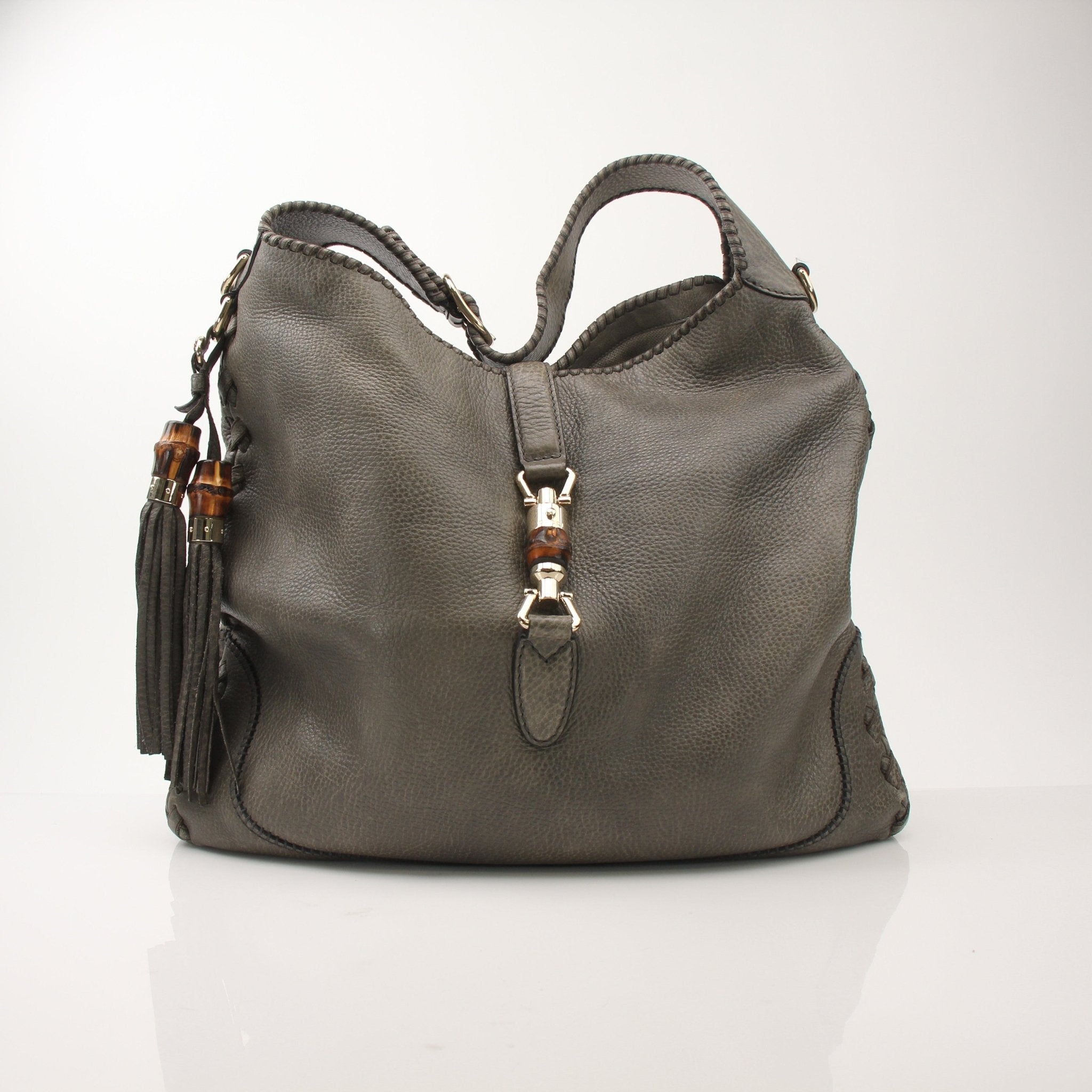 Gucci Pebbled Calfskin Jackie Shoulder Bag with gold-tone hardware and adjustable strap, stylish handbag for women.