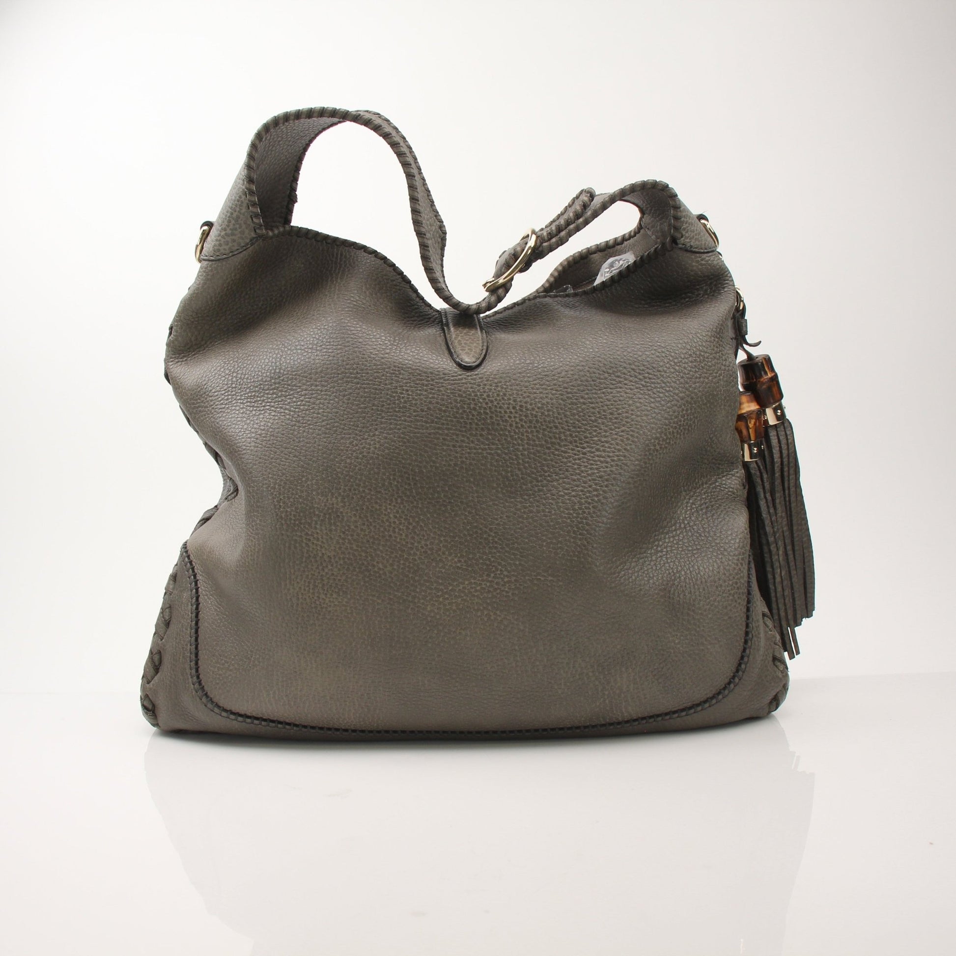 Gucci Pebbled Calfskin Jackie Shoulder Bag with gold hardware, featuring a structured handbag design and adjustable strap.