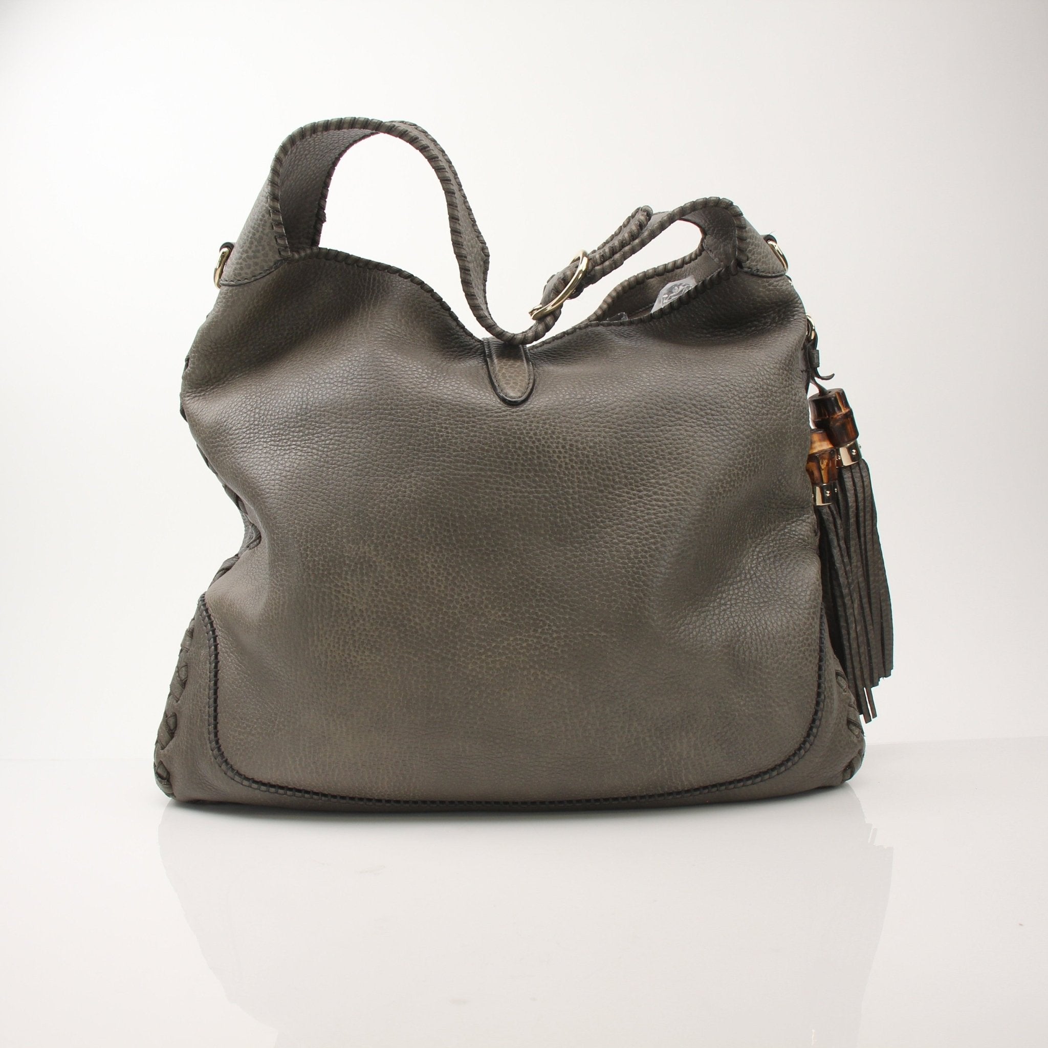 Gucci Pebbled Calfskin Jackie Shoulder Bag with gold hardware, featuring a structured handbag design and adjustable strap.