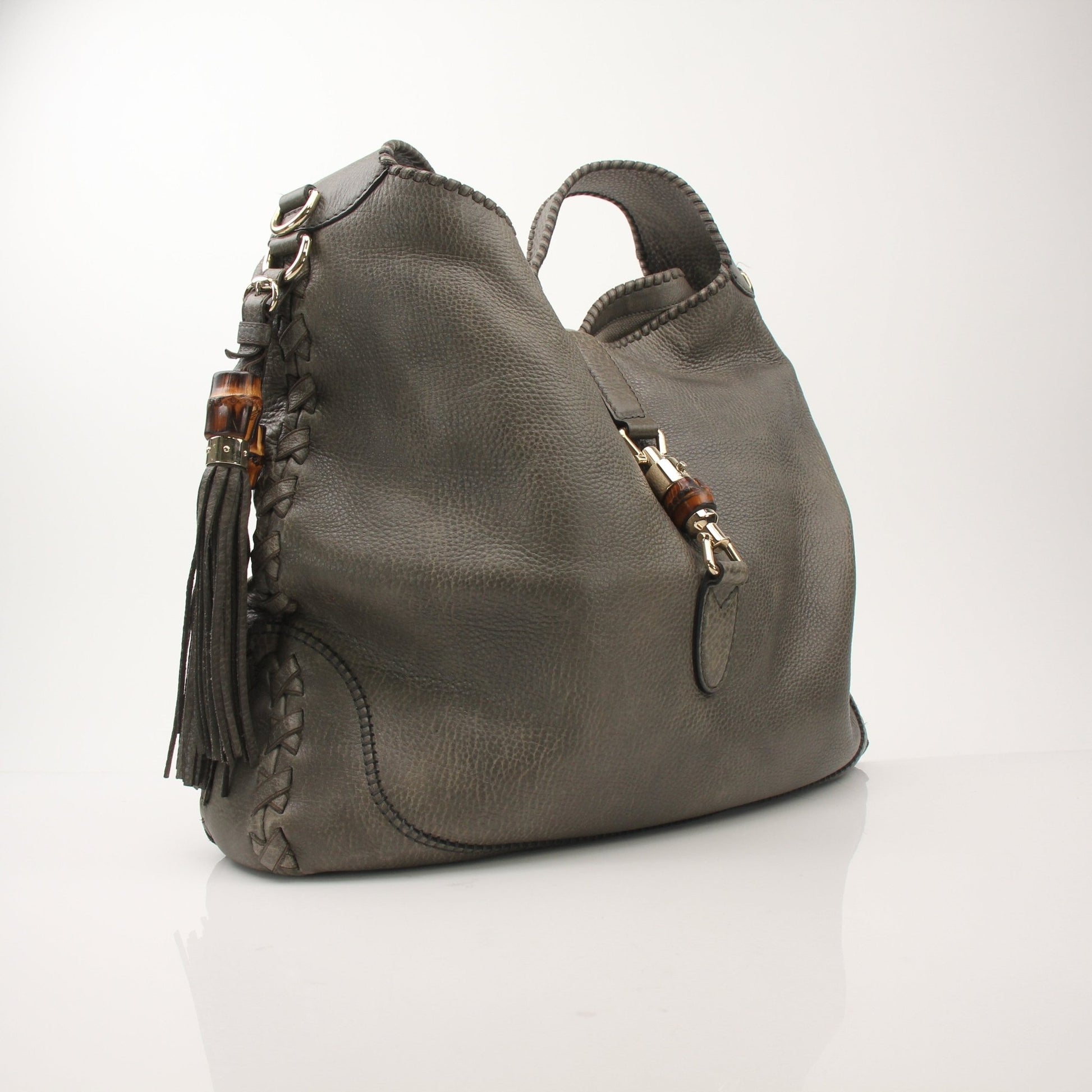 Gucci pebbled calfskin Jackie shoulder handbag with gold hardware, featuring a structured design and adjustable shoulder strap.