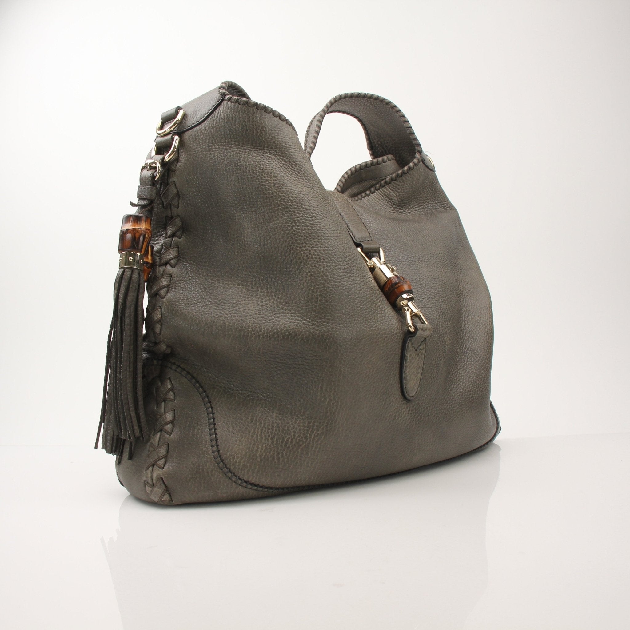 Gucci pebbled calfskin Jackie shoulder handbag with gold hardware, featuring a structured design and adjustable shoulder strap.