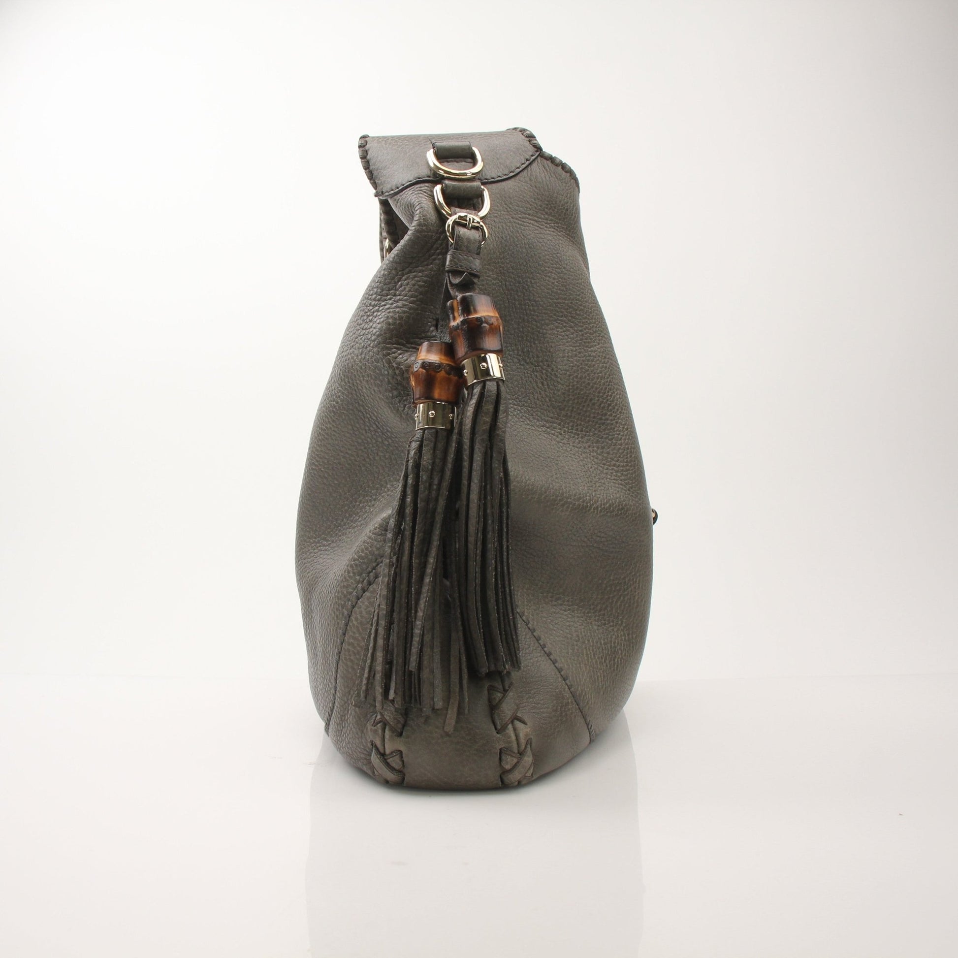 Gucci pebbled calfskin Jackie shoulder handbag with gold hardware, featuring a structured design and adjustable strap.